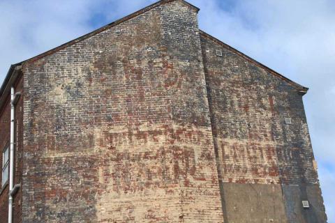  Advert on side wall of 127 High Street